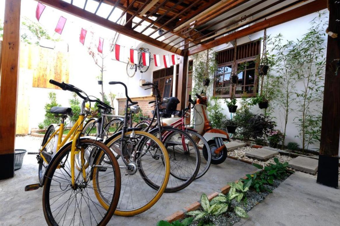Scooter and bicycle parking under a wooden pergola